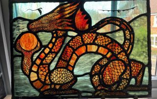 amber dragons logo in stained glass colour