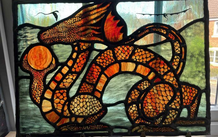 amber dragons logo in stained glass colour