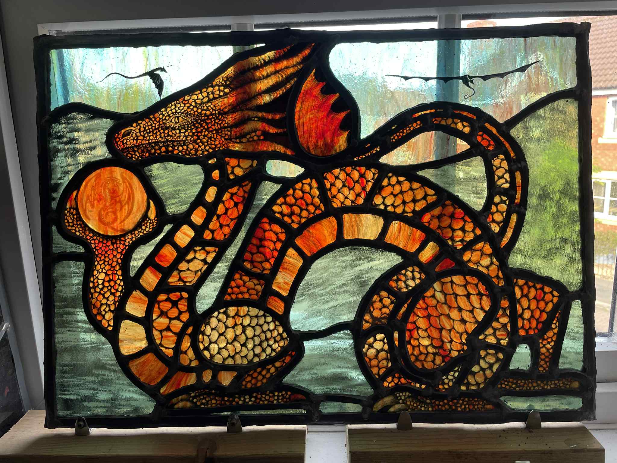amber dragons logo in stained glass colour